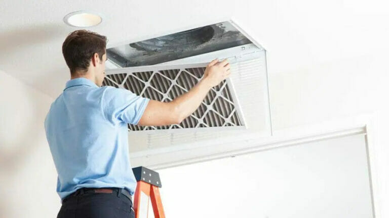 A skilled technician installing an air duct cleaning unit, demonstrating the professional air duct cleaning services provided by Bob's Repair in Henderson, NV