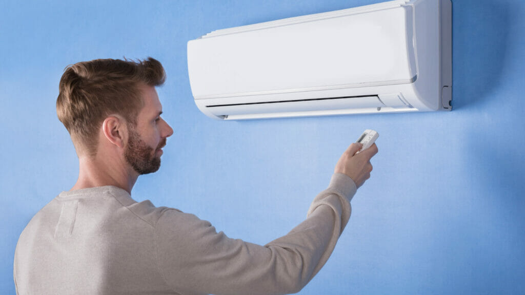 Operating a wall-mounted ductless mini-split with a remote control inside a Paradise residence.