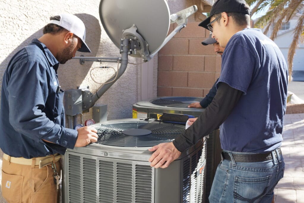Our team of HVAC technicians performing maintenance on outdoor air conditioning units.