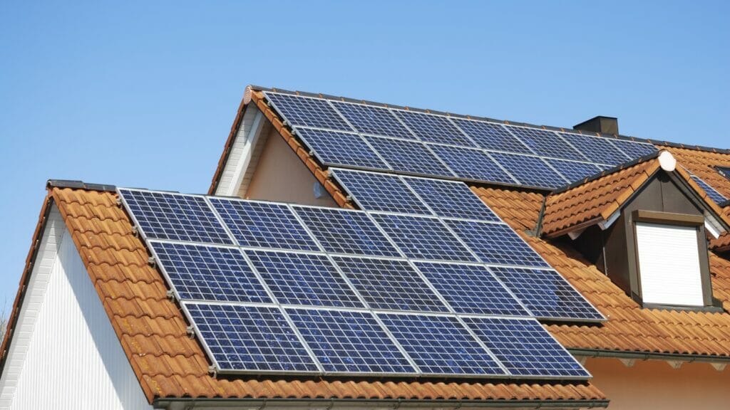 Residential rooftop showcasing a modern photovoltaic solar panel system for sustainable energy generation.