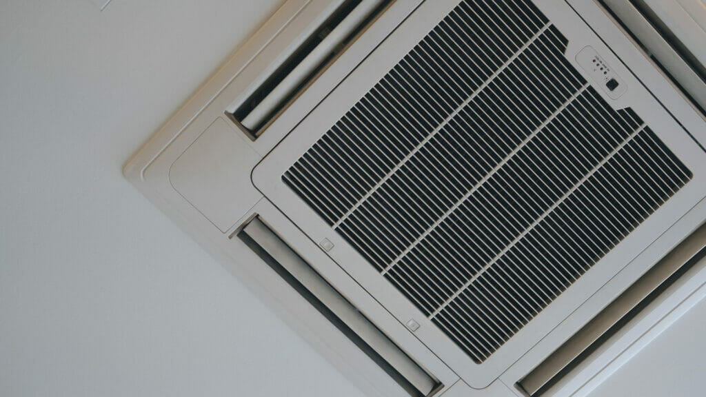 Mounted cassette type air conditioner on a ceiling, representing one of the various types of air conditioning systems you can choose for optimal home comfort.