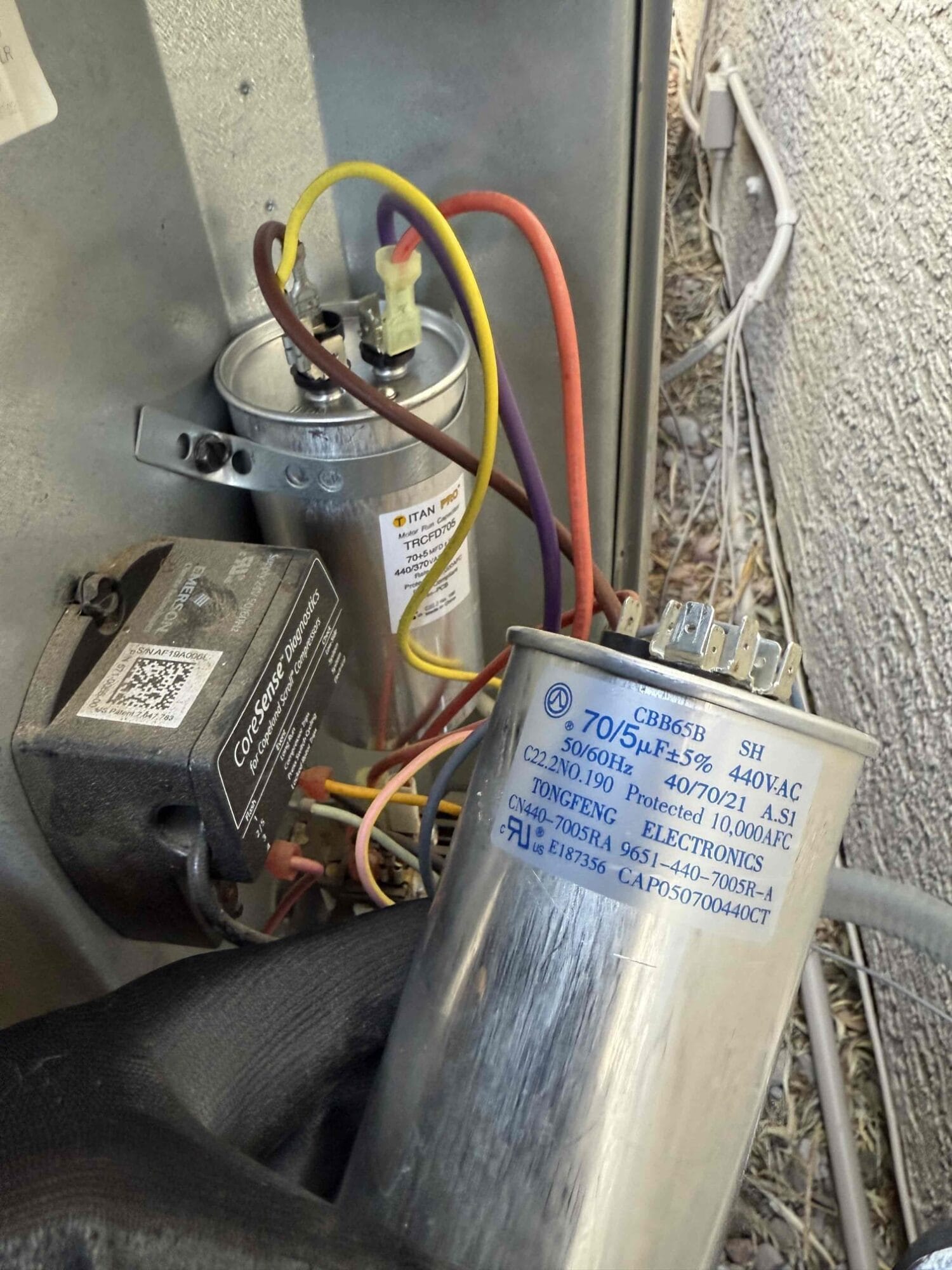 Close-up of the newly installed Titan capacitor properly wired inside the unit