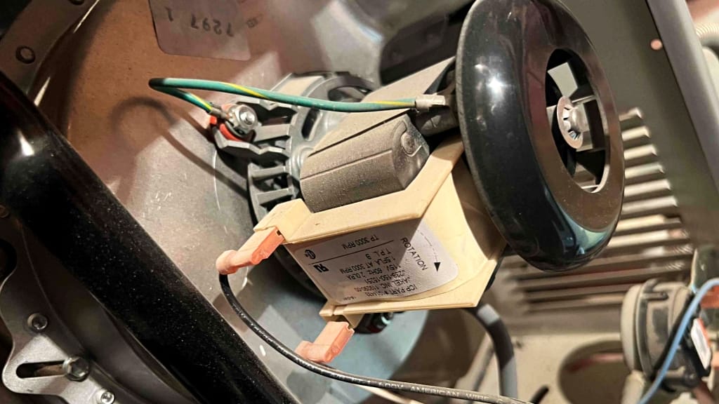 Furnace inducer motor assembly inspected during AC and heating tune-up in Las Vegas to ensure proper airflow and safe ignition.