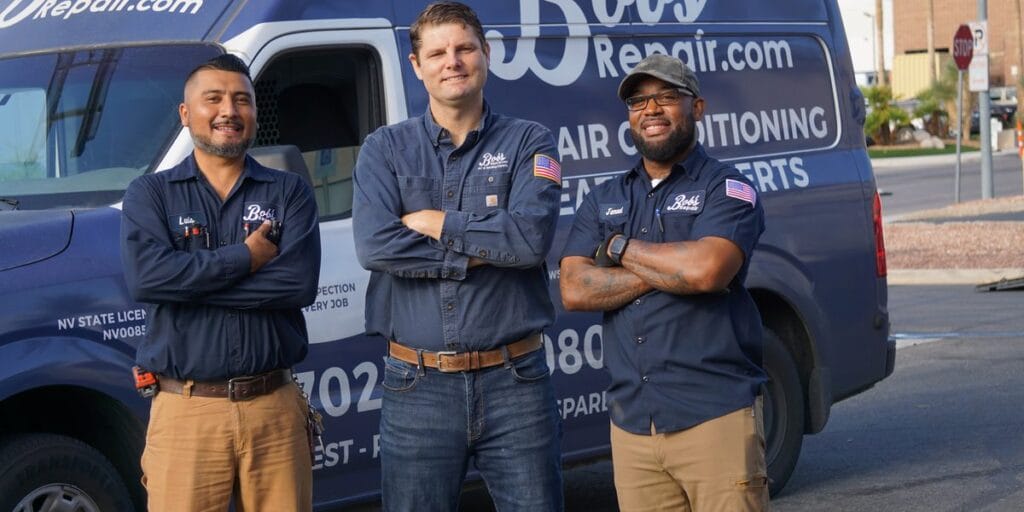Three Bob's Repair technicians stand arms crossed in front of a branded van reading Air Conditioning and Heating Experts.