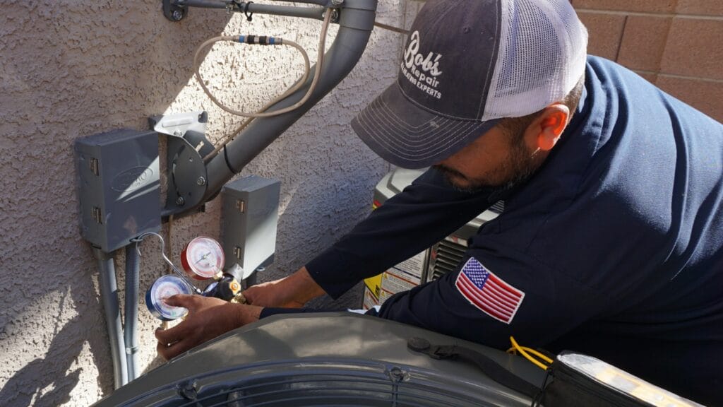 Bob's Repair NATE-certified technician inspecting an outdoor AC condenser unit at a Las Vegas home