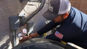 Bob's Repair NATE-certified technician inspecting an outdoor AC condenser unit at a Las Vegas home