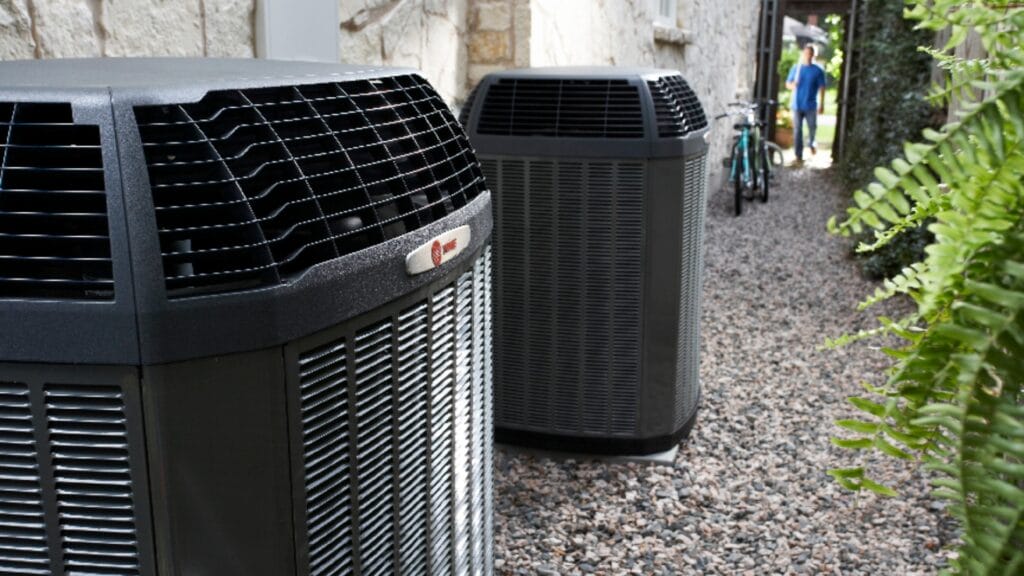 Two outdoor AC condenser units, including a Trane system, installed at the side of a Las Vegas residential home — typical setup for snowbird seasonal AC startup